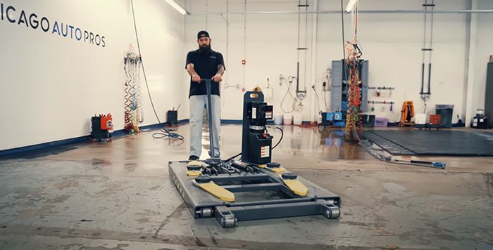 Chicago Auto Pros moving car lift to different shop bay
